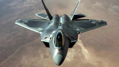 Stealth tactical fighter jet over arid desert terrain in flight