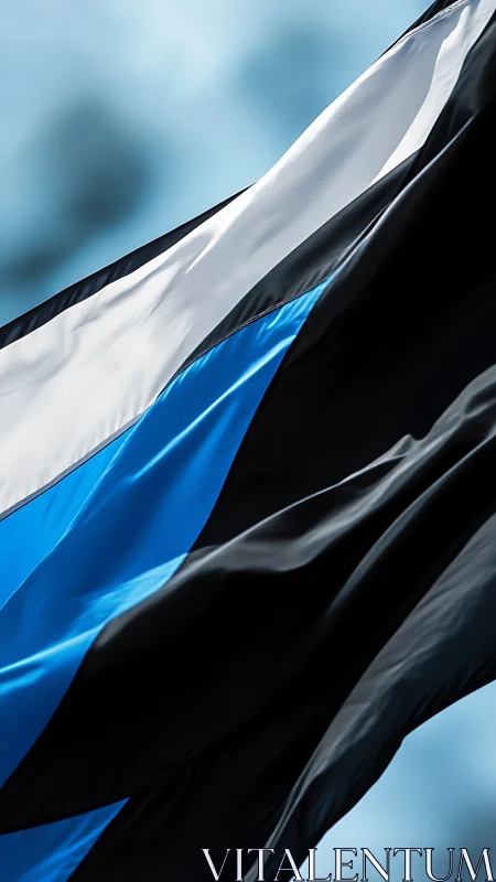 Tri‑colored national flag ripples boldly against the sky