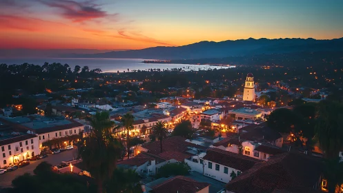 Sunset lanterns over a coastal Spanish-tiled hillside town.