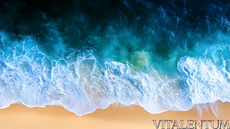 Overhead shoreline view with waves meeting sandy beach.