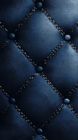 Deep navy tufted leather upholstery with golden stitching.