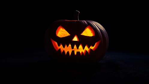 Low-key lit jack-o-lantern with sharp triangular carving geometry