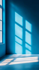 Soft window light casting geometric shadows across blue walls.