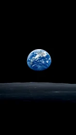 Earthrise over lunar horizon under deep black void.