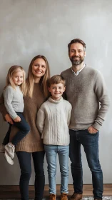 Vertical studio portrait captures coordinated casual family attire