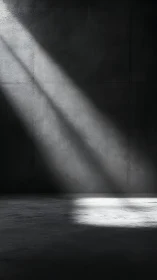 Raking daylight beam across concrete wall and floor plane