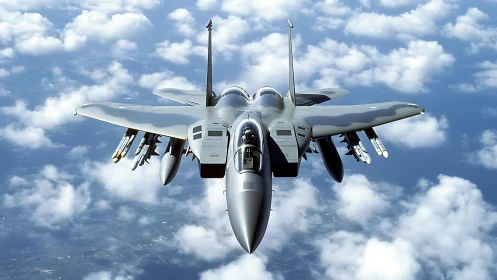 Twin-engine strike fighter cruising above broken cloud layer.