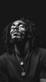 Monochrome portrait with directional key lighting on subject.