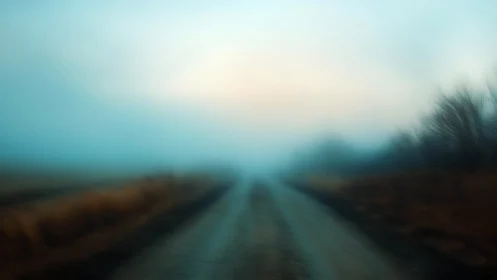 Soft-focus rural road receding into atmospheric blue fog
