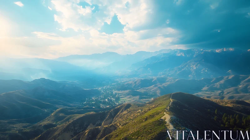 Mountain ridge with valley settlement under layered clouds.