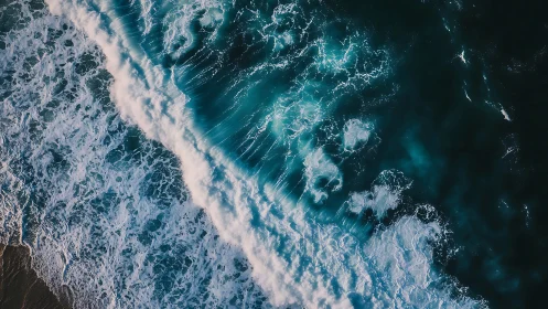 Roaring teal surf captured in dramatic aerial seascape.