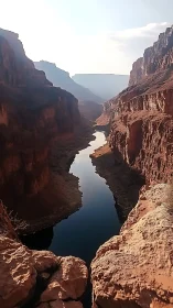 High-walled sandstone canyon with narrow reflective river gorge