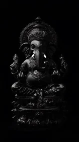 Black sculpted Ganesha figure on dark isolated background.
