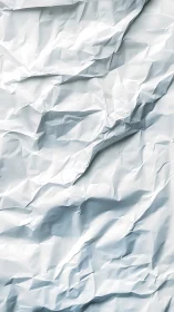 Crumpled paper canyon folds light into soft silver peaks