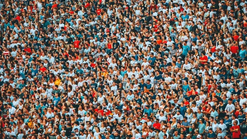 Dense stadium crowd packed tightly into spectator stands.
