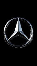 Chrome three-pointed star emblem gleams on deep black background.