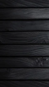 Charcoal-black wooden planks with quietly flowing grain.