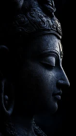Low key sculptural profile of meditative stone deity bust.