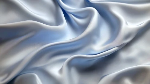 Close-up view of light blue satin fabric with folds pattern.