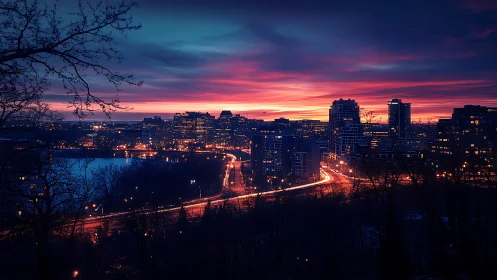 Urban skyline at dusk with illuminated traffic routes.