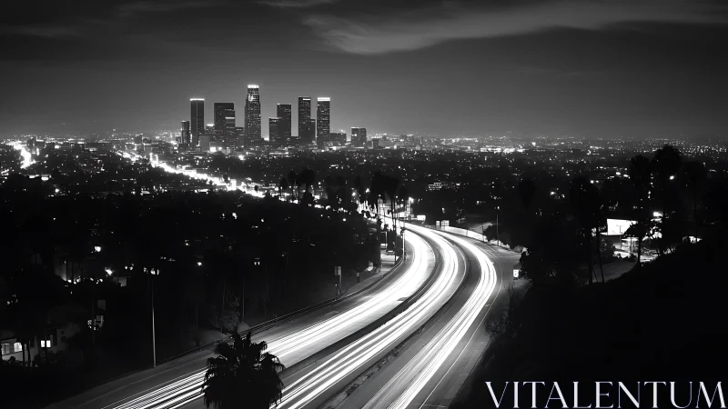 Night freeway curves toward illuminated downtown skyline