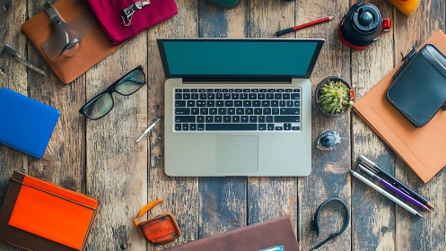 Overhead composition of laptop workspace on rustic wooden desk
