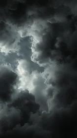 Brooding storm clouds slowly part to reveal pale daylight