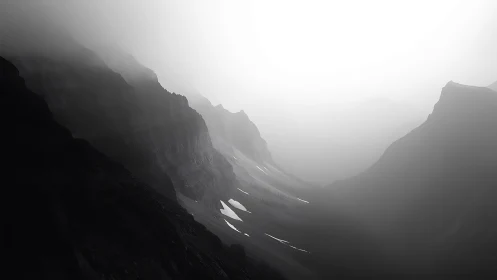 Fog-draped mountain chasm whispers in grayscale silence