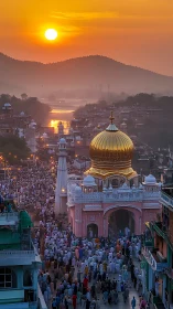 Golden-domed shrine at sunset with dense pilgrimage crowd below