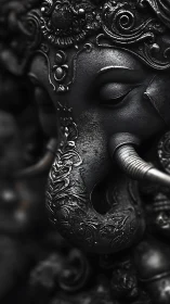 Dark metallic Ganesha sculpture shows intricate embossed ornament