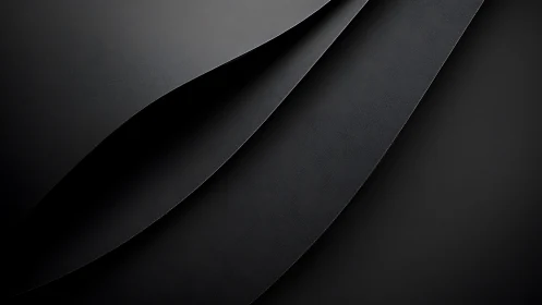Curved matte-black layers intersect, forming minimalist depth study