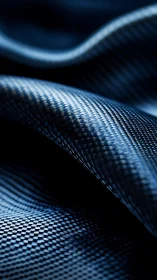 Curved carbon fiber sheet displays woven reflective texture
