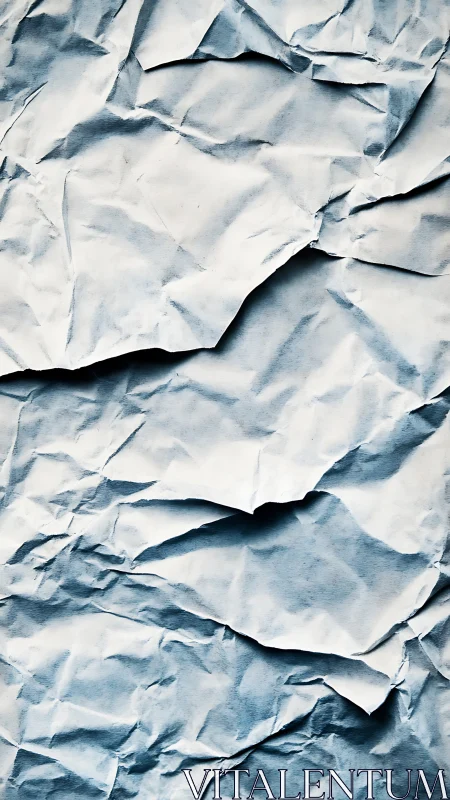 Overlapping crumpled paper sheets with subtle blue tones.