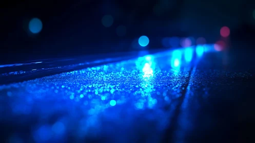 Wet surface reflects linear blue light in shallow focus view