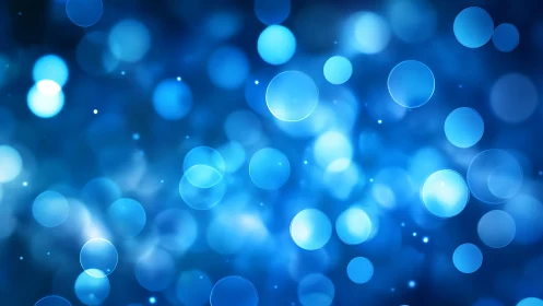 Abstract blue bokeh lights background with soft glowing circles.