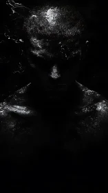 Shadowed figure glows with subtle light in deep darkness