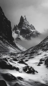 Silent spire of winter rising through drifting mountain mist.