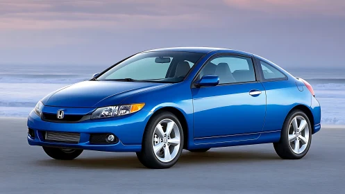 Blue two-door coupe is parked on a coastal roadway