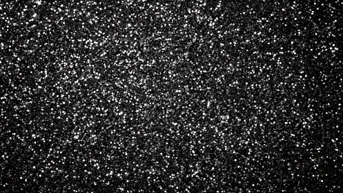 Black glitter surface shimmers with dense metallic sparkle.