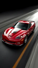 Red sports coupe is captured in motion on a multi-lane road