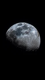 Lunar crescent in high-contrast telescopic close-up study.