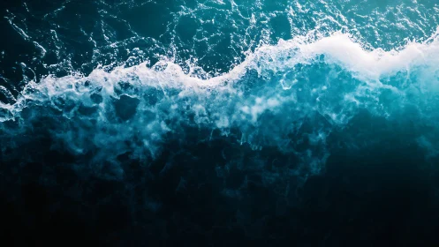 Turbulent ocean wave crest with high-contrast aerial perspective.