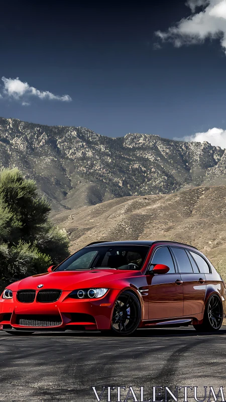 Red sports wagon stands bold beneath rugged mountain skyline.