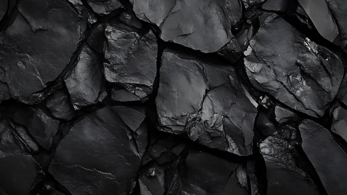 Midnight shale mosaic of fractured obsidian shadows.