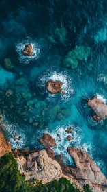 Aerial coastal bathymetry with wave-energized rock outcrops.