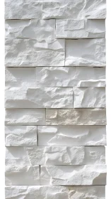 Soft white stone wall with sculpted light and shadow play.