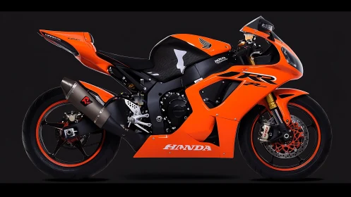 Bright orange Honda sport motorcycle on dark background.