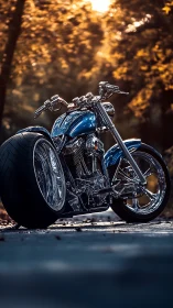 Low-angle custom chopper motorcycle in autumn forest light.