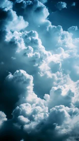 Towering sunlit clouds rise into a deep tranquil blue sky
