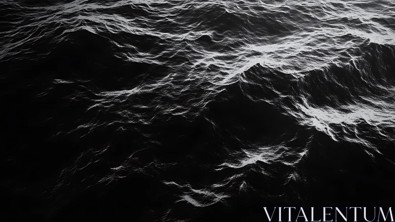 Monochrome ocean waves roll through deep shadowed water.